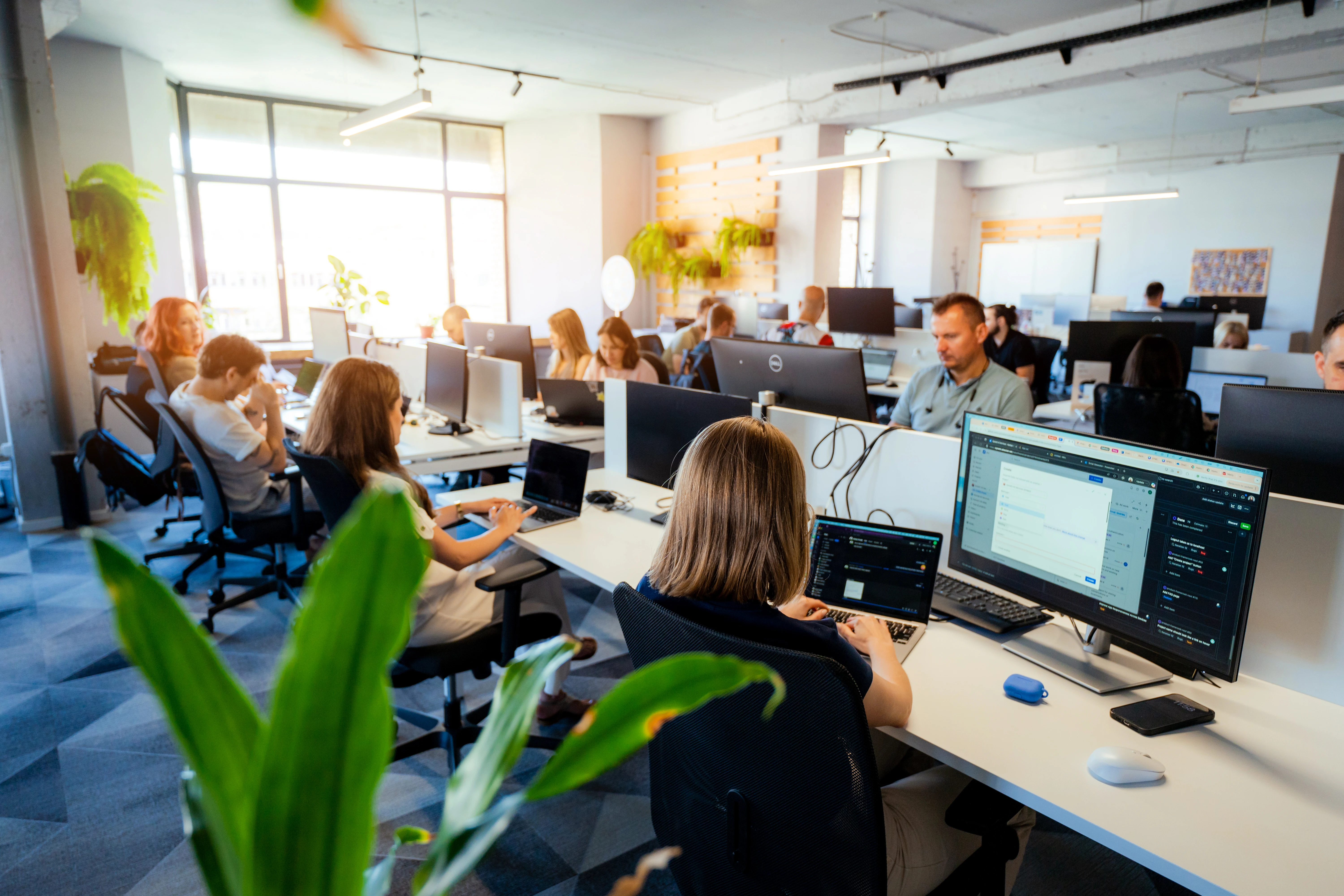 Galeyo team members in a relaxed discussion setting inside a modern glass meeting room